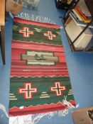 An American/Indian rug, green and red.