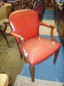 A red hide upholstered open armed Elbow Chair having tapering square front legs terminating in