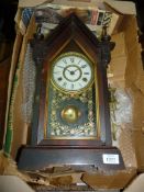 A Jerome wooden cased and glass fronted eight day mantle Clock with key.