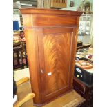 A contemporary Mahogany wall-hanging Corner cupboard having a flame Mahogany door panel,