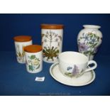 Three Portmeirion storage jars; a Portmeirion vase and a large Portmeirion cup and saucer.