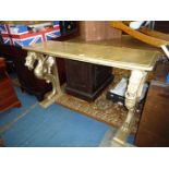 A gold painted Side/Buffet Table standing on supports resembling Phoenixes with metal rings in