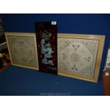 Two framed embroidered panels with silver thread work to the edge and floral centre,