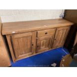 A good mid Oak Sideboard having three cupboards with raised and fielded panelled doors and a drawer