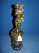 A bronze figure of a nude woman with long hair.