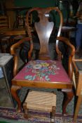 A very elegant Mahogany and Walnut framed Elbow Chair having shaped splat,