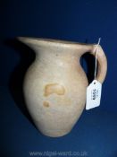 An Alabaster jug, cream/red, 7" tall,