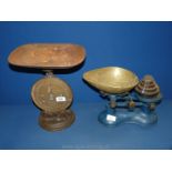 A pair of blue metal weighing scales with weights plus a family scales.