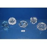 A group of five Orrefors crystal glass candle holders, all signed on bases, one has ice blue tints,