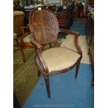 An attractive Mahogany framed open armed Elbow Chair having oval caned backrest,