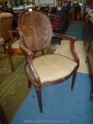 An attractive Mahogany framed open armed Elbow Chair having oval caned backrest,