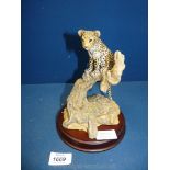 A Teviotdale Leopard Cub on loose wooden base, 8 1/2'' high.