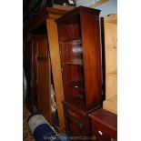 A contemporary Mahogany narrow Bookcase on bow fronted cupboard base with splay bracket feet,