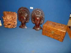 Three wooden masks plus an oriental wooden box.