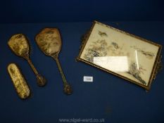 An oriental print tray with mirror and two brushes.