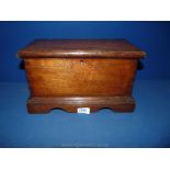 An early 19th c. Mahogany Casket in the shape of a blanket chest with shaped base and bracket feet.