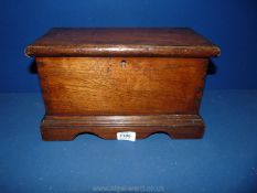 An early 19th c. Mahogany Casket in the shape of a blanket chest with shaped base and bracket feet.