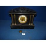 A Victorian slate mantle Clock with four pillars and clock striking mechanism,