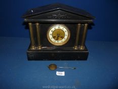 A Victorian slate mantle Clock with four pillars and clock striking mechanism,