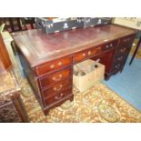 A reproduction Mahogany double pedestal Desk having inset maroon,