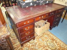 A reproduction Mahogany double pedestal Desk having inset maroon,