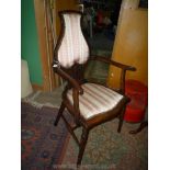 An Edwardian Beech and other woods arts and crafts Elbow Chair having turned legs,