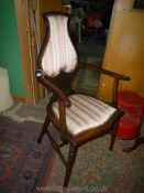 An Edwardian Beech and other woods arts and crafts Elbow Chair having turned legs,