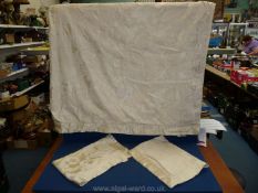 A king size duvet cover and two pillow cases in cream having an embossed pattern throughout.