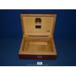 A highly polished wooden cigar box/humidifier.