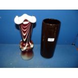 A vintage Murano style glass vase with wavy rim and three bulging hoops above deep base in maroon,