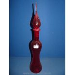 A tall red glass with lid.