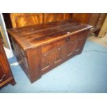 A four-panel Oak Blanket Chest of peg-joyned construction having linen-fold details of a style that