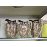 Three Crown Ducal jugs in all over floral pattern, two 8" and one 7" (lid missing).
