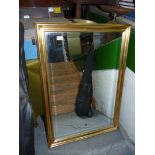 A large bevelled glass mirror in a gilt frame. 28 1/4" x 40 1/4".