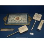 A glass dressing table tray with lace under the glass on spade feet and with embroidered brush,