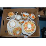 A 1960's part dinner service 'The Young Range' bright orange floral design including coffee pot,