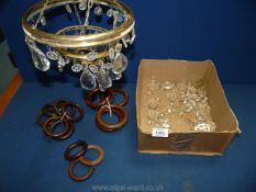 A cut glass ceiling light, some droplets detached and a quantity of curtain rings.