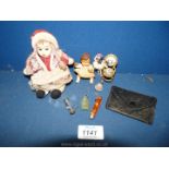 Two small dolls, a small leather purse, tiny bell,