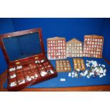 A quantity of thimbles in four display cases and loose thimbles, some metal.