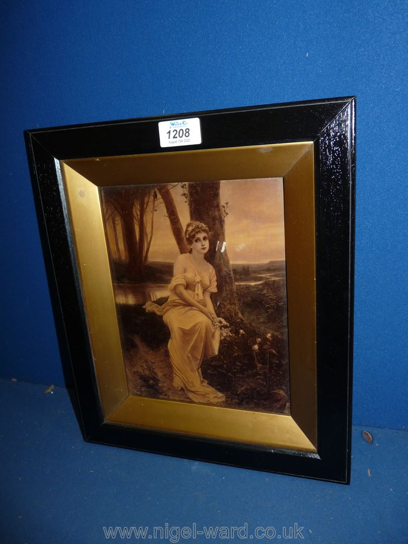 A late Victorian crystoleum of a young woman seated under a tree by a river.