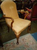 An elegant Walnut & Mahogany framed Elbow Chair standing on cabriole front legs with carved