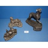 Three bronze dogs including Boxer, German Shepherd and Doberman.