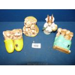 A Beswick Beatrix Potter 'Mrs Rabbit' and three Moorcraft rabbit figures