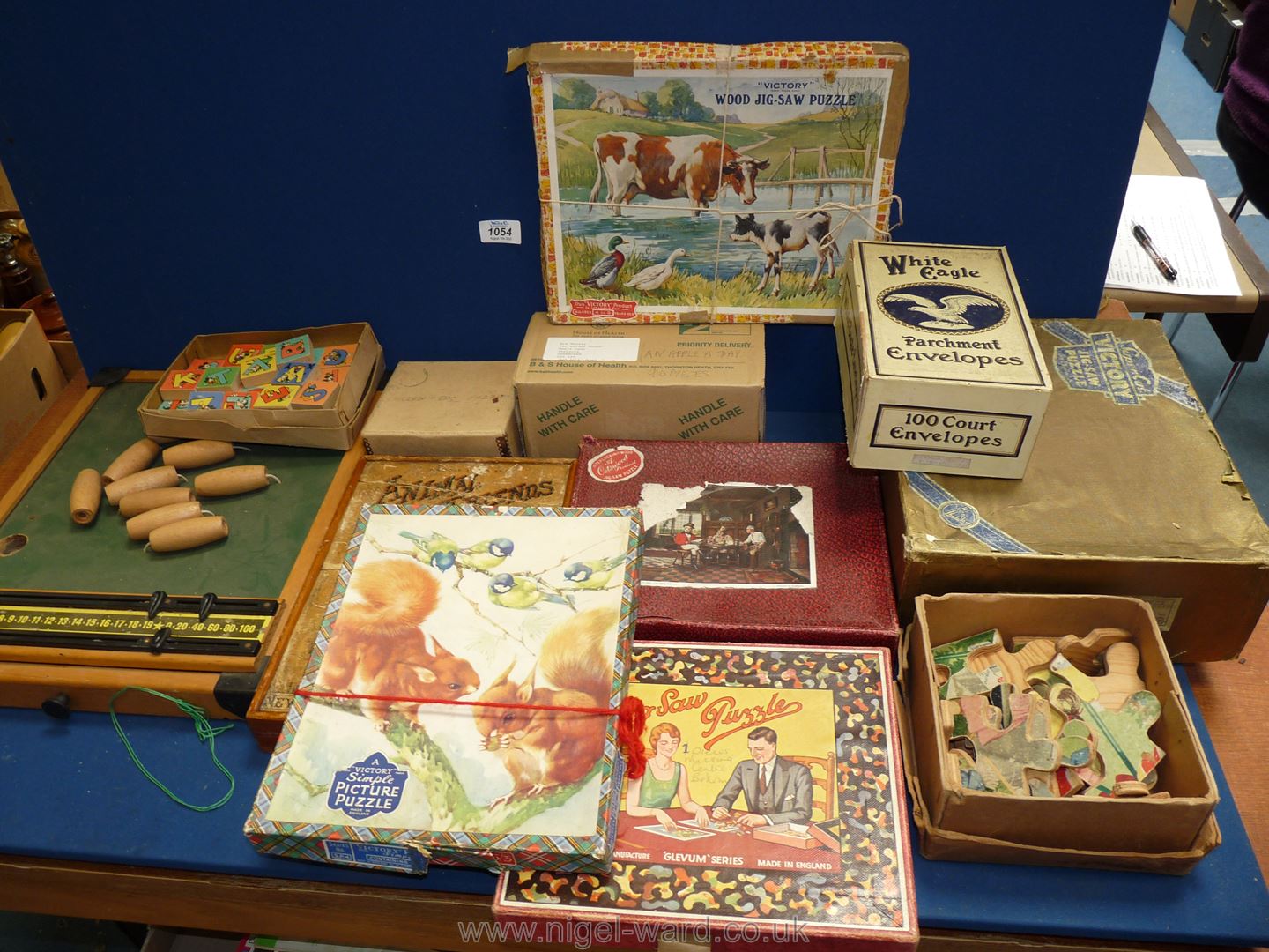 A box of assorted wooden puzzles including animal friends puzzle and a Bar Skittles game (ball