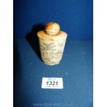 An old Japanese bone snuff bottle decorated with scenes of an erotic nature, 3 1/2'' tall.