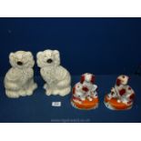 A pair of brown mantle dogs each with a puppy at their feet,