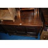 A dark Oak Mule Chest having three raised and fielded panels to the front with two short drawers