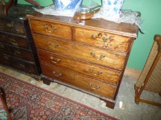 An early 19th century Mahogany chest of 3 long and 2 short drawers having light-wood strung detail
