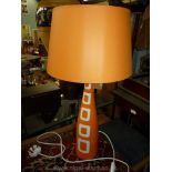 A tall, slim modern design Louis Drimmer orange table lamp and matching shade.