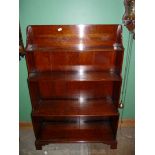 A Satinwood waterfall Bookcase/Bookshelves standing on bracket feet and having reeded edge,